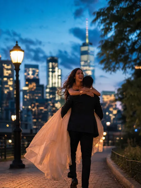 Couple piggybacking along park path with city skyline lights at blue hour engagement photos