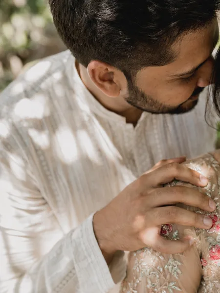 Close-up of a whisper between couple on a tree-lined avenue, engagement photos